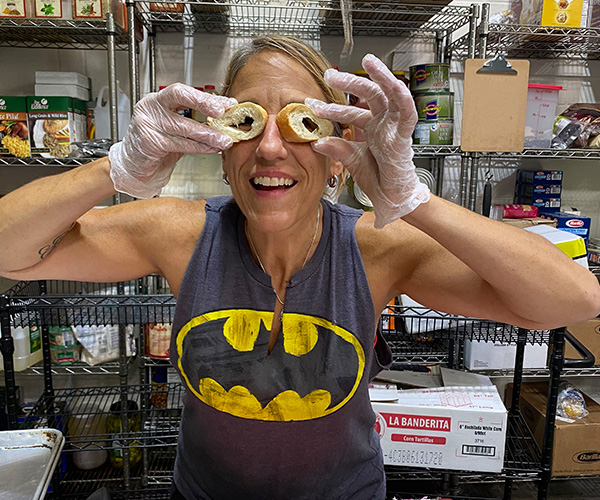 Betsy holding two pieces of hollowed out bread up to her eyes to make eyeglasses