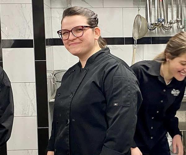 Marissa Hart and other catering staff in the kitchen